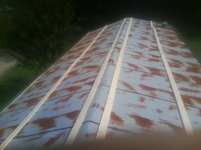 Rusted metal roof panels with new wood purlins before replacement — Storm Damage Roof Repair in Wallula by Roofing Brothers